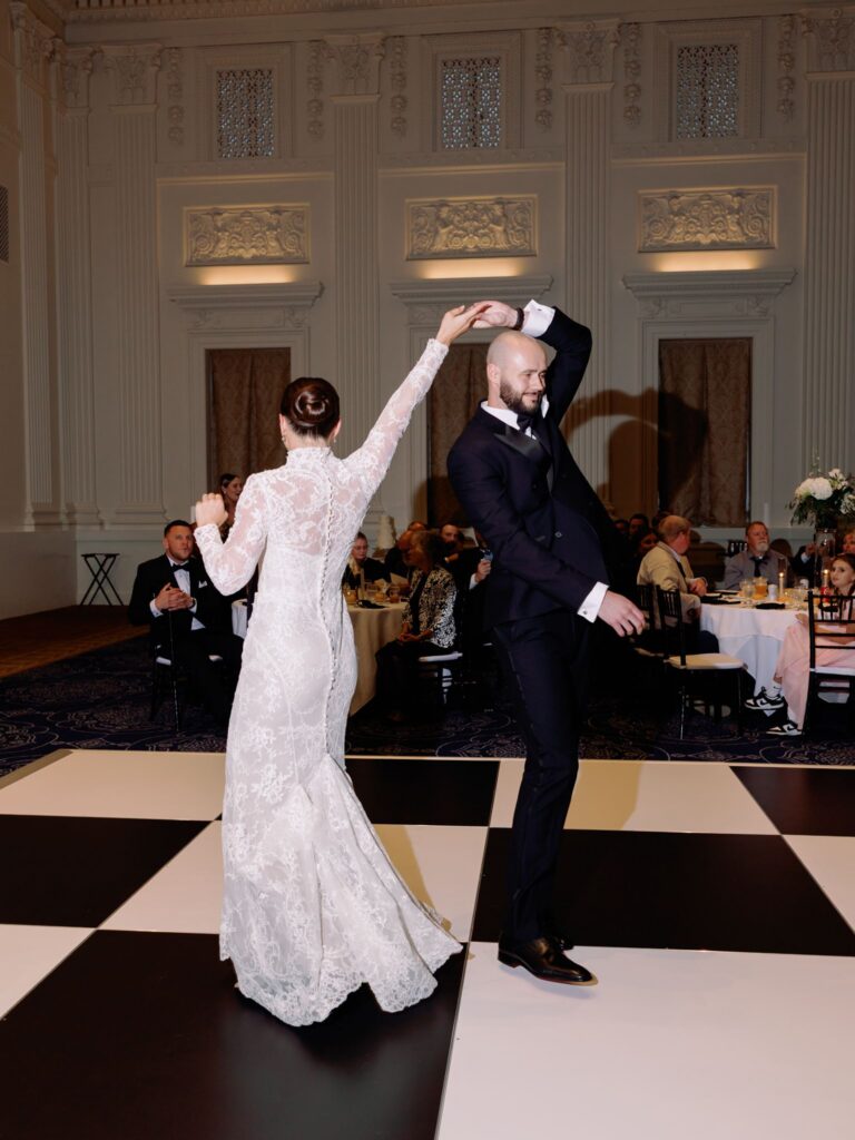 Newlyweds twirling on dance floor